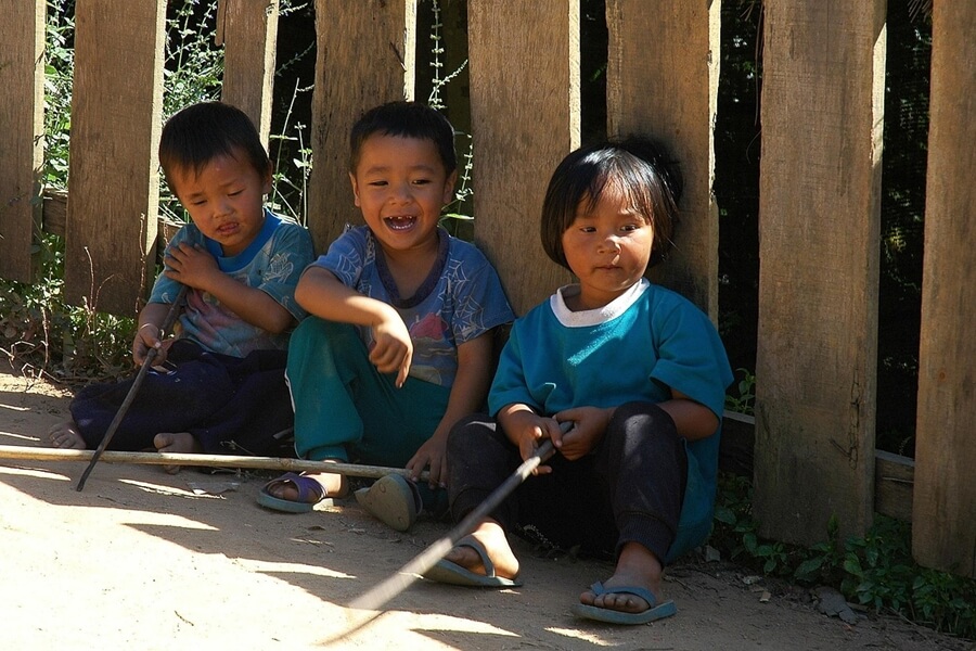 Kinderen in Thailand die buiten spelen met bescherming tegen muggen